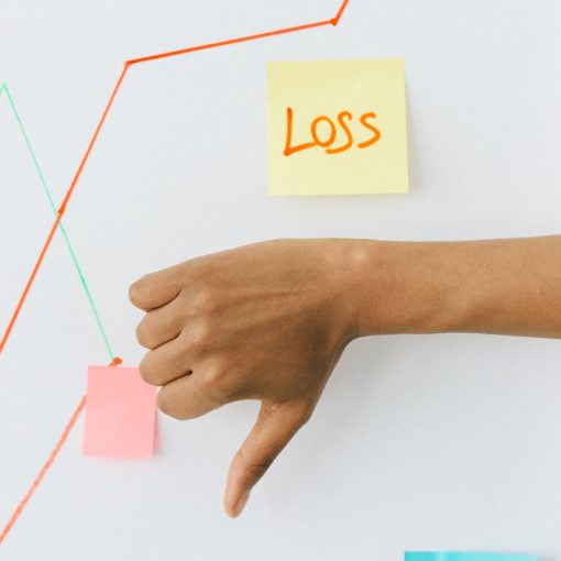 person holding orange and white sticky note