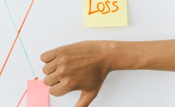 person holding orange and white sticky note