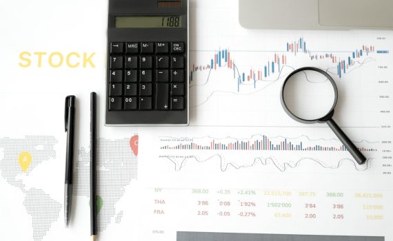 calculator and magnifying glass on survey sheets