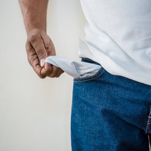 person in blue denim jeans holding white textile