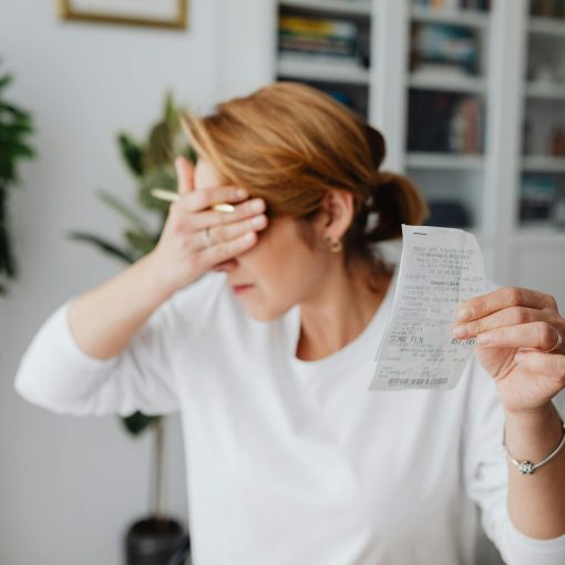 unhappy woman holding bill