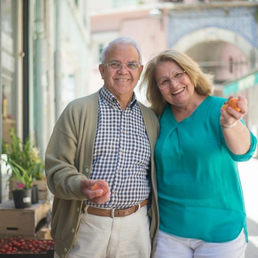 smiling elderly couple buying groceries