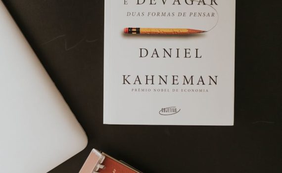 flat lay of book and planner on dark desk