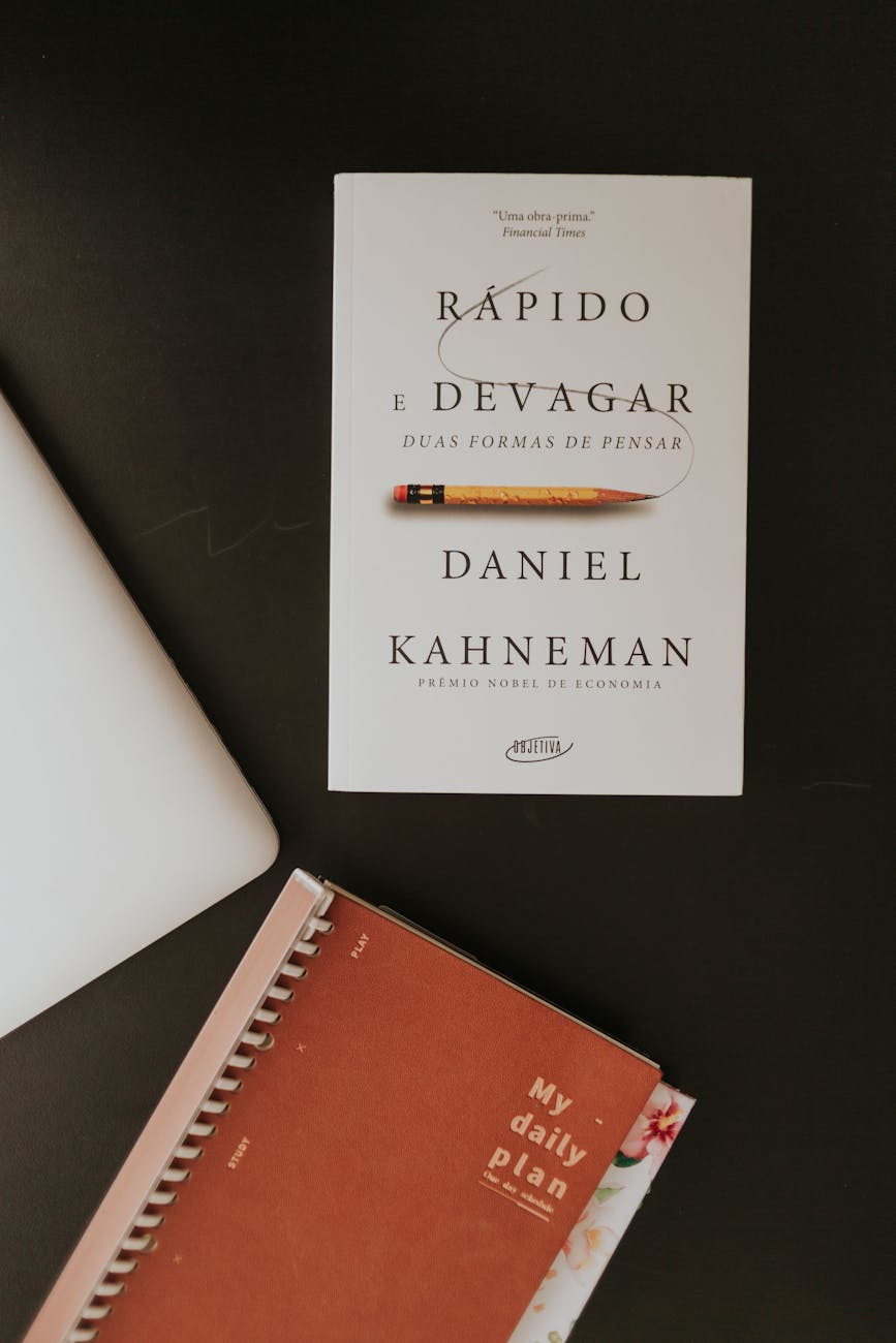 flat lay of book and planner on dark desk