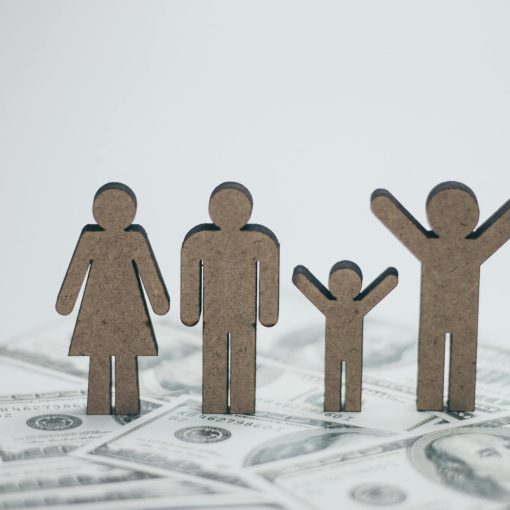 wooden family dolls on cash