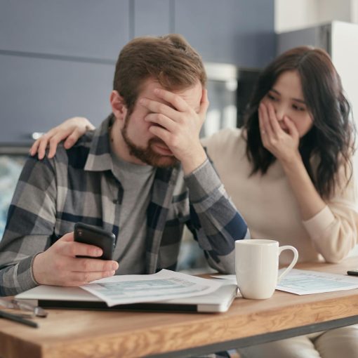 a man covering his face in frustration