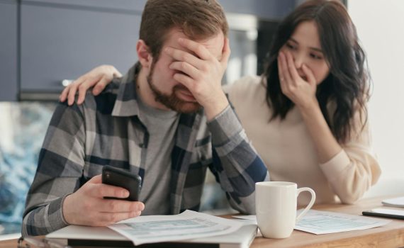 a man covering his face in frustration