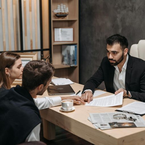 a man in black suit talking to his clients