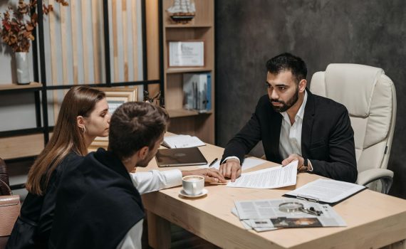 a man in black suit talking to his clients